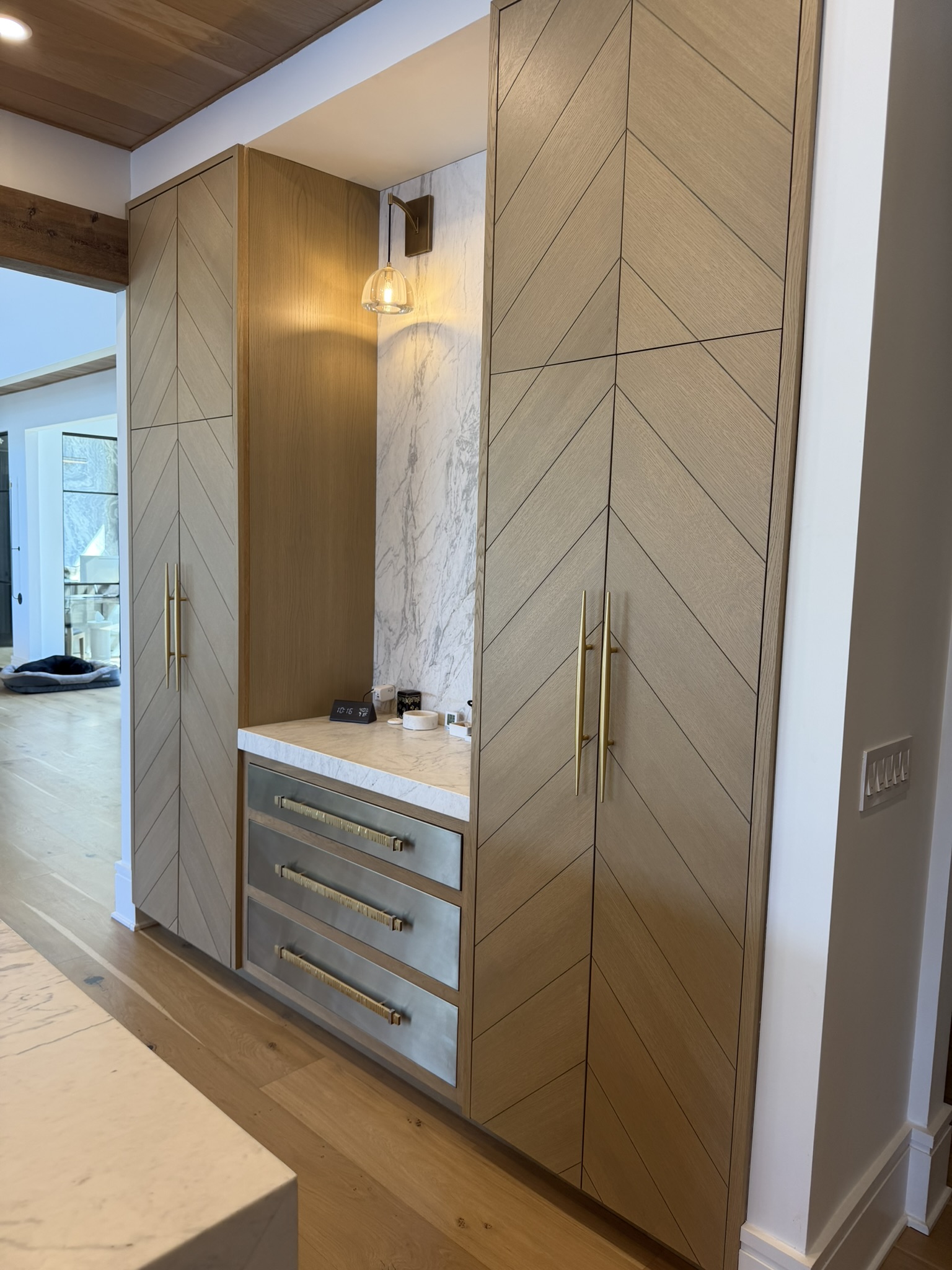 Chevron cabinet doors with brass hardware